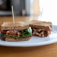 BLT  · Hardwood smoked bourbon bacon, tomatoes, greens, roasted garlic aioli, wheat toast .