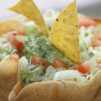 Taco Salad · Tortilla shell filled with beans, rice, lettuce, onions, tomatoes, and guacamole.