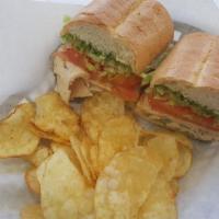 Grilled Chicken Pesto Sandwich · Grilled chicken breast, pesto, provolone cheese, lettuce and tomato on a French roll with th...