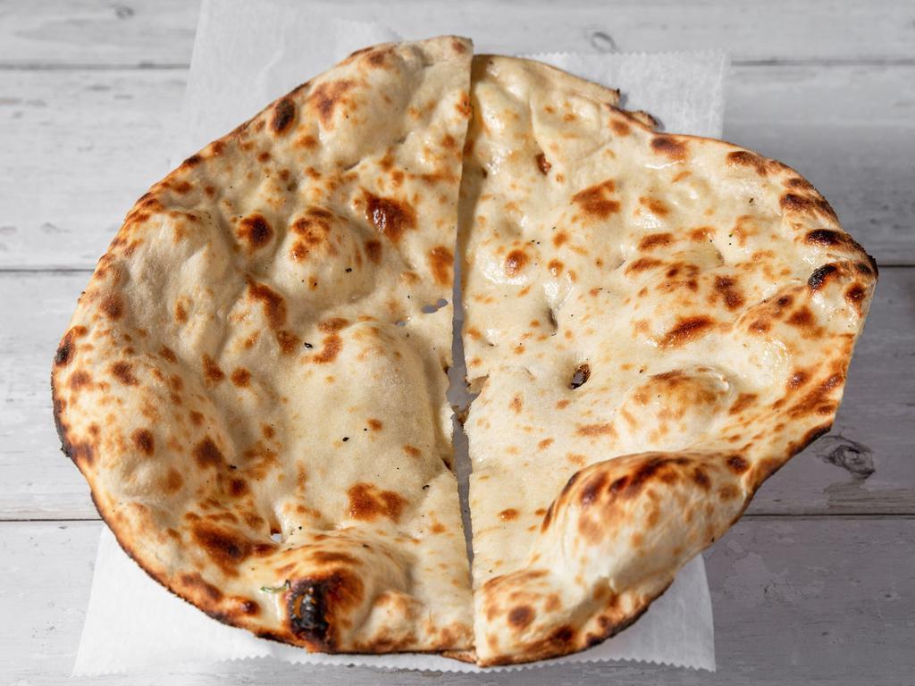Naan · Traditional bread baked in the clay oven.