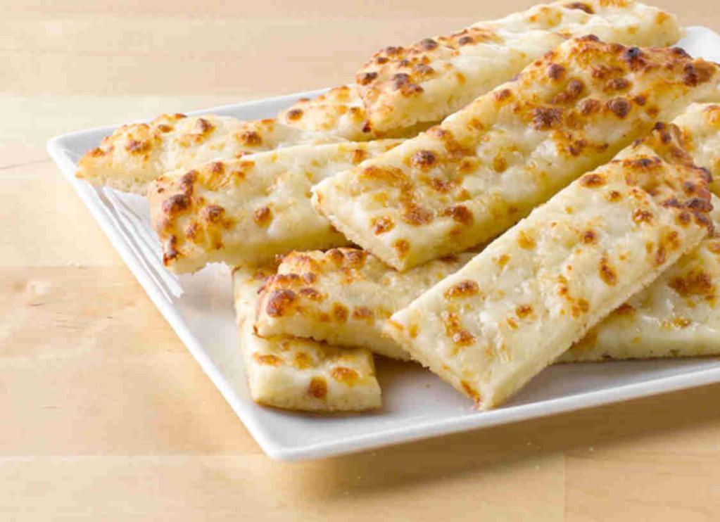 Cheesesticks · Fresh dough topped with special garlic sauce and mozzarella cheese, then baked fresh. Served with choice of dipping sauce.