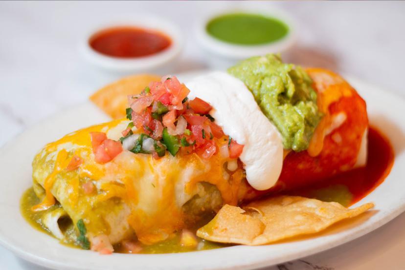 5 de Mayo Burrito · Choice of filling, rice and beans topped with green and red sauce, melted cheese, guacamole, pico de gallo and sour cream.