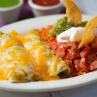 Enchiladas Suizas · 2 semi-fried tortillas filled with meat or vegetables. Topped with a creamy tomatillo sauce ...