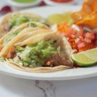 Aztecas Tacos · 3 traditional Mexican soft tacos. Served with rice, beans, guacamole, pico de gallo and sour...