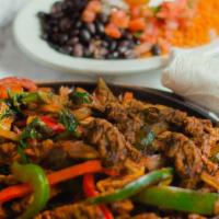 Skirt Steak Fajita Platter · Skirt steak sauteed with bell peppers, onions and chef sauce. Served with rice, beans, guaca...
