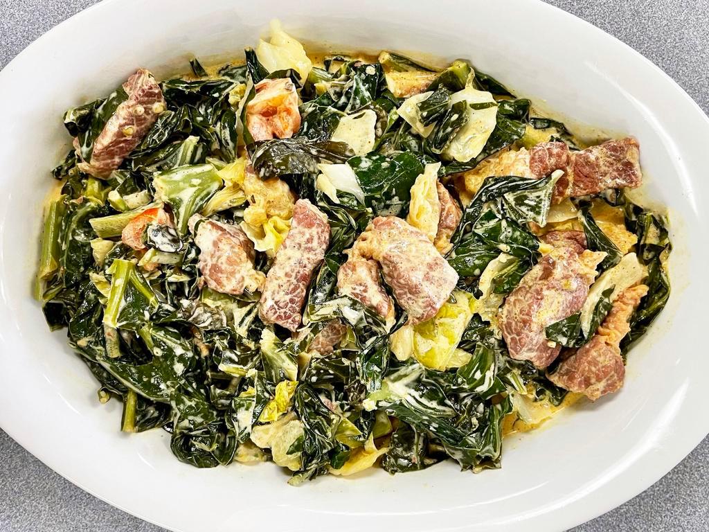 Pelepulumasima · Collard greens prepared with salted corn beef, coconut milk, and fresh vegetables, surely an island delight.