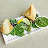 Lamb Samosa · Crispy pastries stuffed with ground lamb and peas, lightly seasoned with spices.