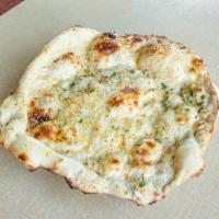 Garlic Naan · Garlic Naan, Indian flat bread topped with garlic and cilantro. Vegetarian.