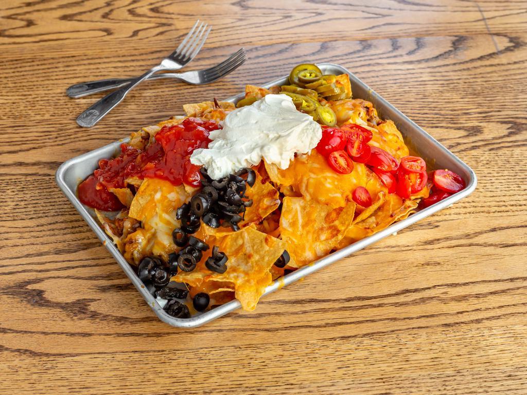 Taco Nachos · House fried tortila chips, seasoned taco beef, melted cheddar cheese, sliced jalapenos, sliced cherry tomatoes, black olives, sour cream and salsa.