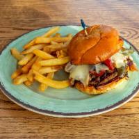 Philly Burger · Our black angus burger topped with American cheese, shaved ribeye, peppers and onions.