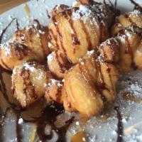 Sweet Knots · Twisted dough knots drizzled with chocolate anddusted with powdered sugar.