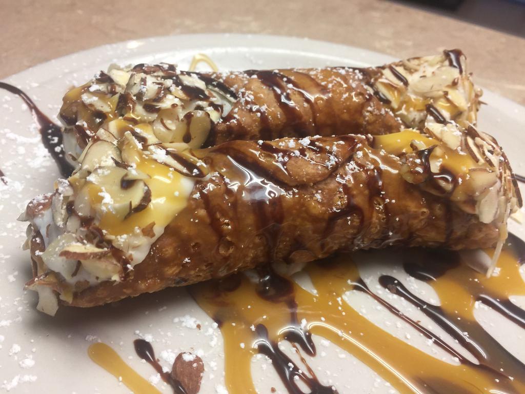 Cannoli · Two Cannolis filled with custard drizzled with chocolate and caramel 