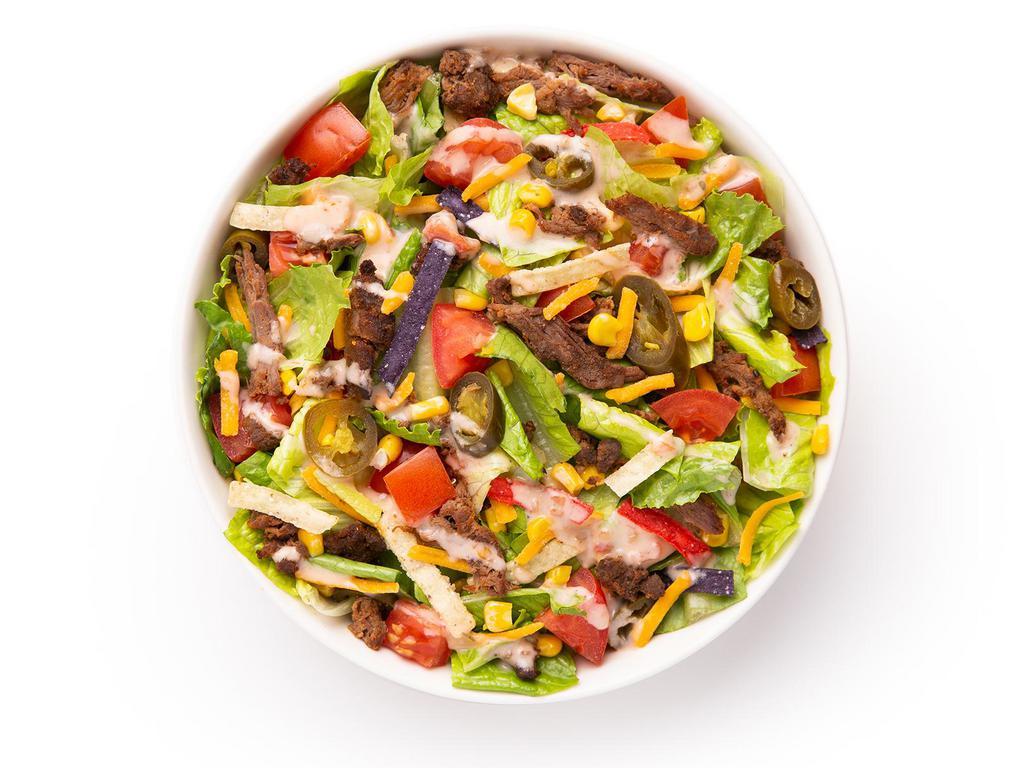 Beef Taco Fiesta Signature Salad · Say Ole’ to the Fiesta: romaine/iceberg blend or super greens blend, warmed braised beef, diced tomatoes, cheddar cheese, jalapenos, sweet corn, tri-color tortilla strips, topped with salsa ranch dressing.