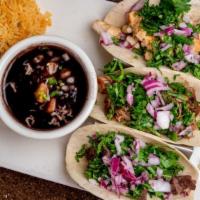 Taco Mix Grill · 3 tacos: 1 steak, 1 grilled chicken and 1 carnitas topped with fresh onions and cilantro. Se...