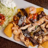 Texas Fajita Nachos · Our delicious marinated mix of steak, chicken and shrimp grilled with onions and bell pepper...