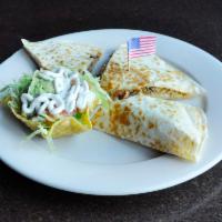 Texas Fajita Quesadilla · Marinated steak, chicken and shrimp grilled with onions and bell peppers inside your cheese ...