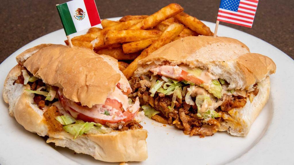 Torta Mexicana · “Torta” sandwich with your choice of meat or style. Stuffed with lettuce, tomato, avocado slices and honey habanero dressing. Served with your choice of side: fries, rice, charros or black beans.  