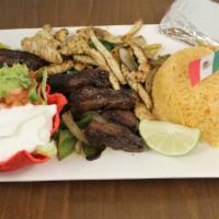 L5. Fajitas Lunch · Our Delicious marinated grilled fajitas come on a bed of bell peppers and onions. Accompanie...