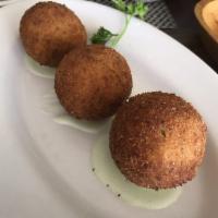 Papa Rellena · Mashed potato ball stuffed with beef, chicken or cheese, lightly battered, and fried to cris...