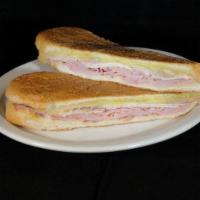 Cubano Sandwich · A combination of thin sliced home roasted pork, premium ham, melted Swiss cheese, pickles, m...