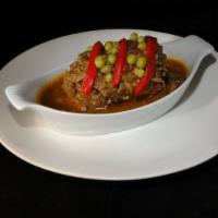 Bistec Relleno · A sirloin steak rolled and stuffed with ham, bacon, onions, olives, parsley, simmered in fre...