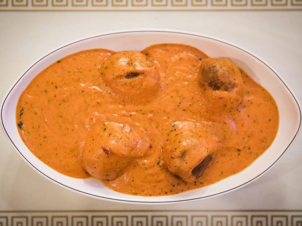 Malai Kofta · Homemade cheese stuffed in vegetable balls, cooked in a mildly spices creamy, and almond sauce.