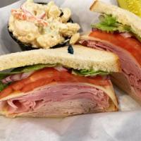 The Twist Sandwich · Sliced roasted turkey and ham topped with Swiss cheese, shredded lettuce, tomato, red onion ...