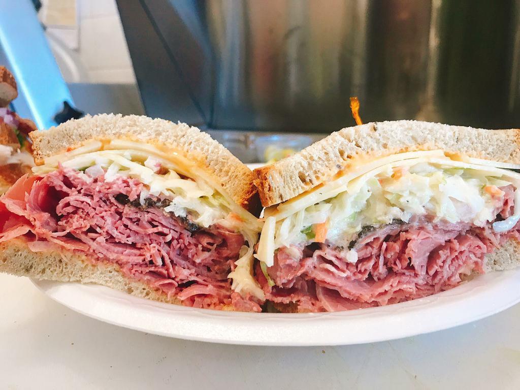 The Double Sandwich · Corned Beef & Pastrami, Topped with Swiss Cheesed, Homemade Cole Slaw, & Thousand Island Dressing