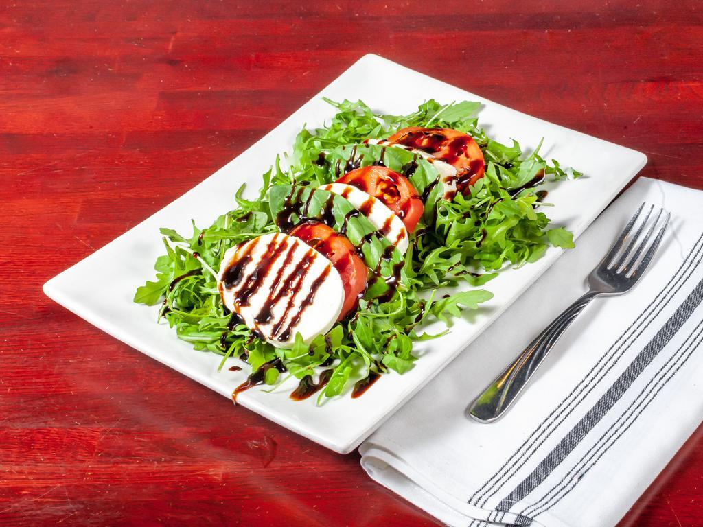 Mozzarella Caprese · Basilico favorite, gluten-free, vegetarian. Slice mozzarella, sliced beefsteak tomato served over our arugula and basil blend with a drizzle of aged balsamic reduction. 