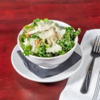 Kale Caesar Salad · Romaine hearts, fresh kale tossed in our signature Caesar dressing with roasted garlic crout...