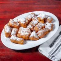 Signature Zeppoli · Fried sweet dough tossed with powdered sugar and served with chocolate and caramel on the si...