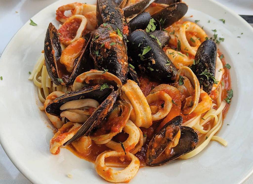 Seafood Pasta · Mussels, clamari, shrimps and salmon over pasta. Served over pasta with a side of bread.