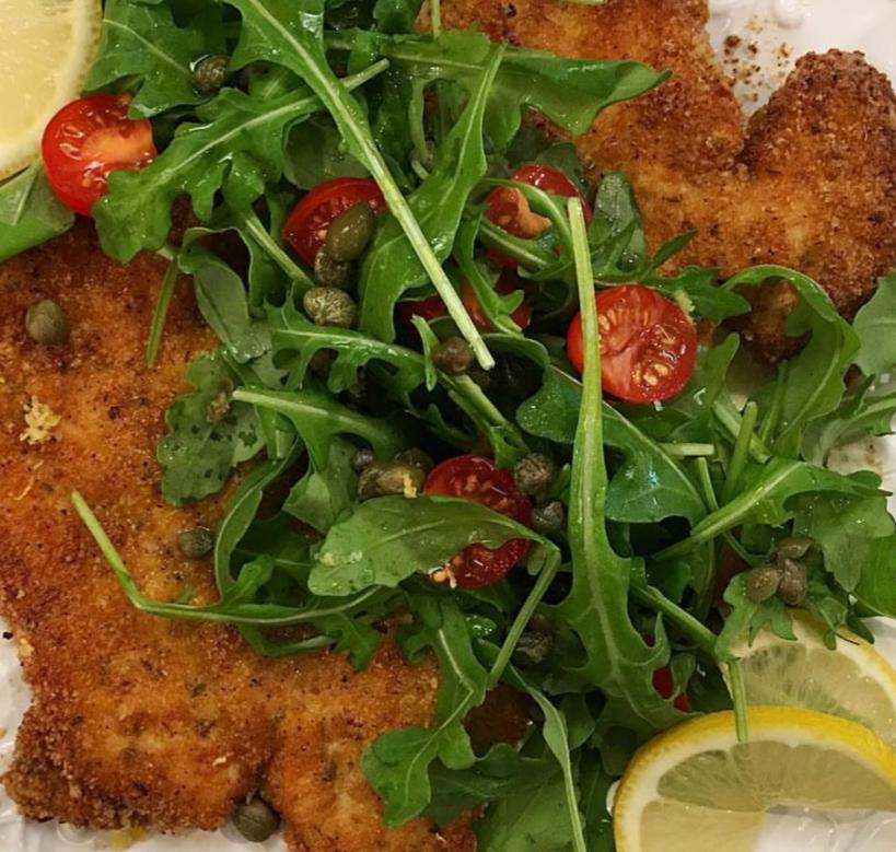Chicken Milanese · Over baby arugula, red onions, tomatoes, lemon and olive oil. Served over pasta with a side of bread.