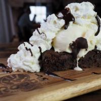 Brownie Sundae · Warm old fashioned brownie topped with either vanilla or chocolate ice cream. Finished with ...