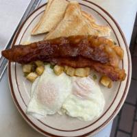 The Milkman Combo · 2 eggs, Southern browns, toast, your choice of sausage, bacon or ham, and milk.