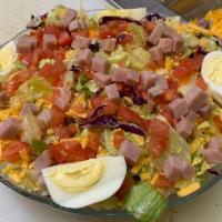 Chef Salad  · Crisp iceberg lettuce and tomato salad topped with diced ham, cheddar cheese, and boiled egg.