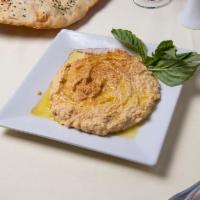 Hummus · Delicious combination of garbanzo bean mixed with tahini, garlic, lemon juice with olive oil.