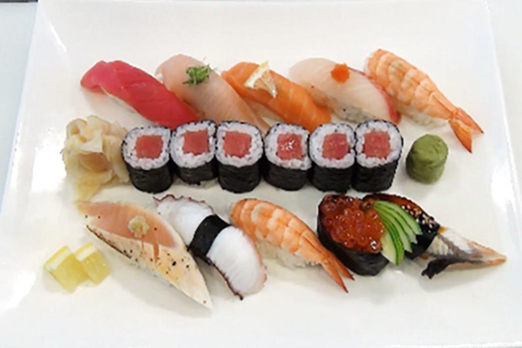 Sushi Combination Deluxe · Tuna Roll served with a piece of tuna, salmon, salmon roe, snapper, eel, yellowtail, shrimp, albacore and octopus nigiri.