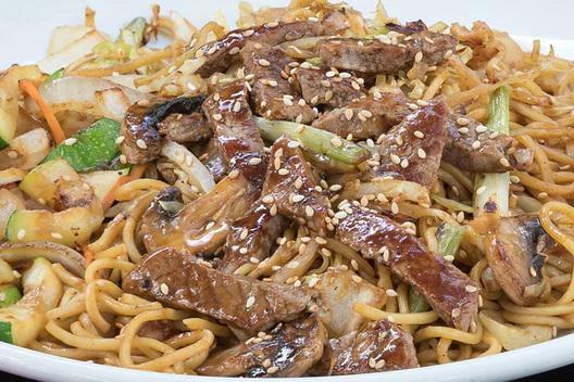 Steak Yakisoba · Japanese sautéed noodles with steak and mixed vegetables in a special sauce and sprinkled with sesame seeds.