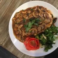Veal Marsala · Medallions of veal sauteed in Marsala wine sauce with fresh mushrooms in a light brown sauce.