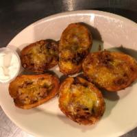 Loaded Potato Skins · Comes with cheese blend, bacon, and sour cream.