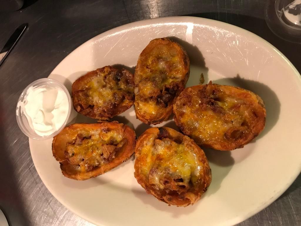 Loaded Potato Skins · Comes with cheese blend, bacon, and sour cream.