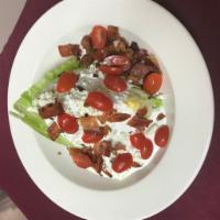 Wedge Salad · Crispy iceberg lettuce, diced tomatoes, bacon, blue cheese crumbles and creamy blue cheese d...