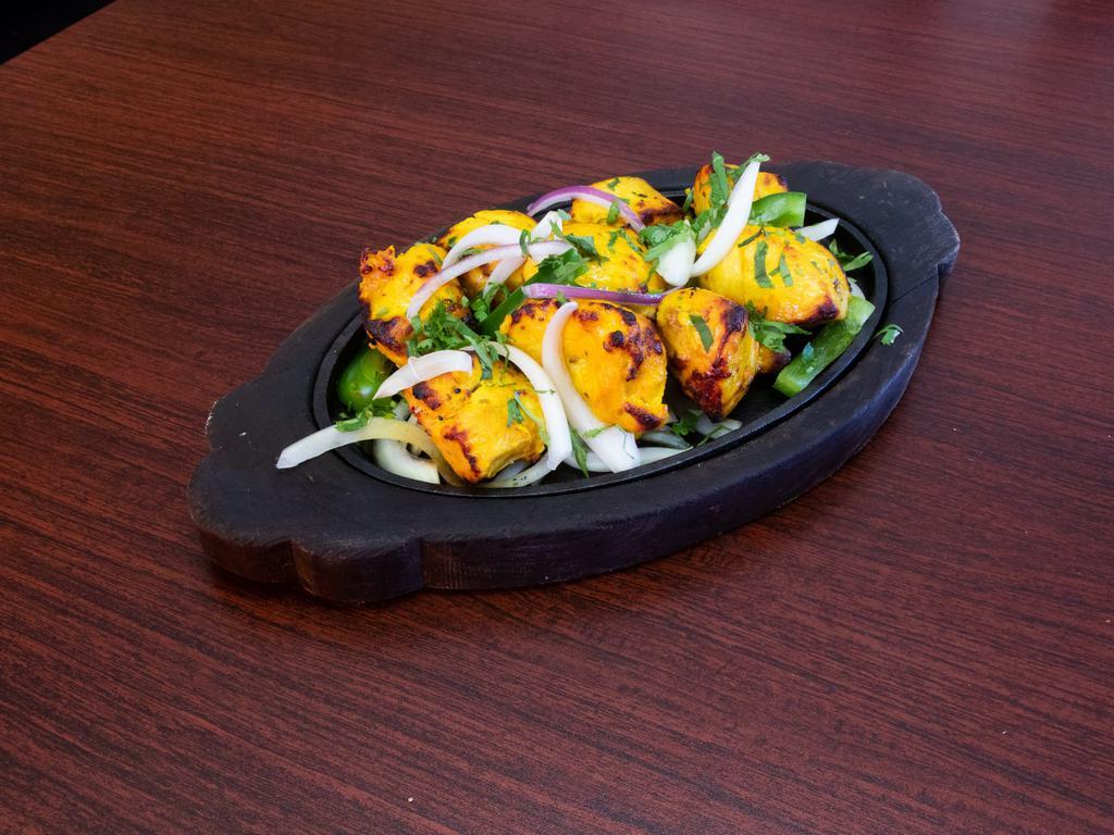 Tandoori Chicken Tikka · Chicken​ marinated in yogurt sauce and spices and baked in the clay oven.