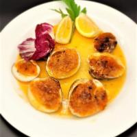 Baked Clams · Cooked in a white wine lemon sauce and covered with breadcrumbs.
