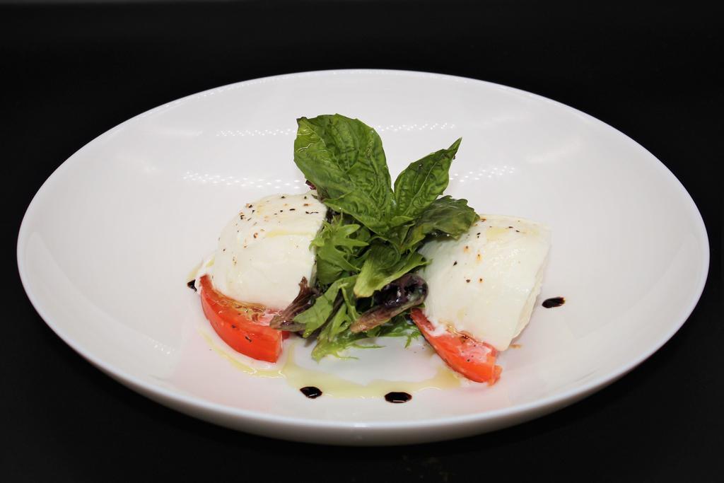 Buffalo Mozzarella and Beefsteak Tomatoes Salad · Sliced beefsteak tomatoes and mozzarella “sandwiched” in between. The mozzarella cheese is made with 100% pasteurized whole milk, Served with Extra virgin olive oil.