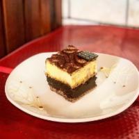 Tiramisu · Chocolate sponge brushed with coffee syrup, layered with crunchy hazelnuts & creamy mascarpone