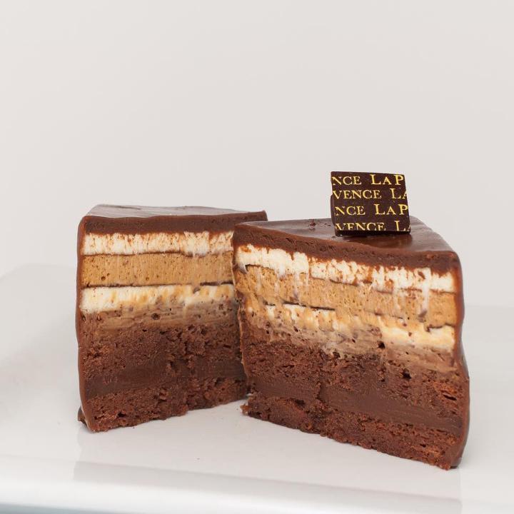 Versaille · Chocolate sponge layered with vanilla, coffee, and dark chocolate mousses, covered with dark chocolate ganache