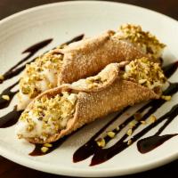 Traditional Cannoli · Two crisp pastry shells stuffed with sweet ricotta and chocolate chip filling, topped with p...