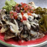 Nacho Supreme · Fresh Tortilla Chips topped with Meat, Beans, Cheese, Guacamole, Sour Cream, Jalapeno. Choic...